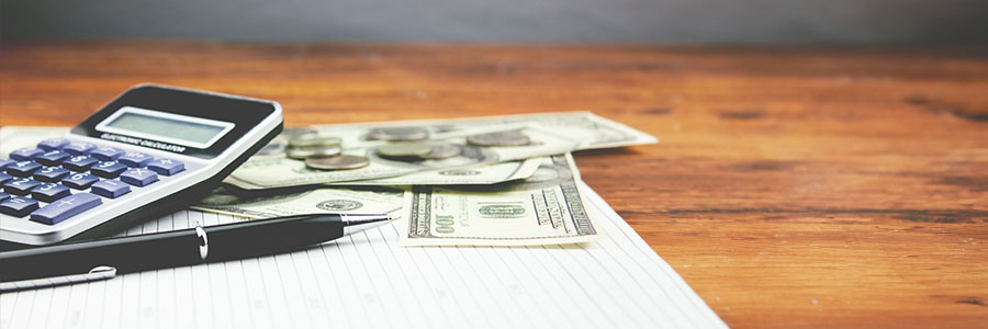Article teaser image. Calculator and money laying on a table.